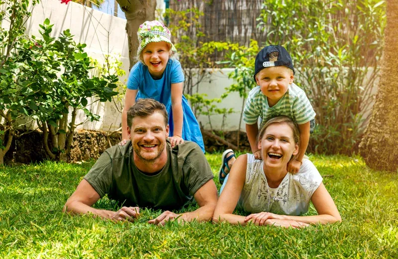 family outside laying on green grass